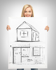 Image showing woman holding picture with house