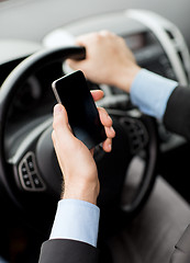 Image showing man using phone while driving the car