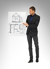 Image showing man holding picture with house