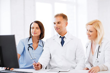 Image showing doctors looking at computer on meeting