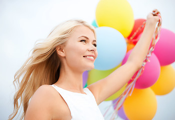 Image showing woman with colorful balloons outside