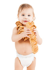 Image showing cute todler eating long bread