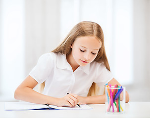 Image showing little student girl drawing at school