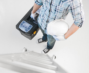 Image showing man with ladder, helmet and toolkit