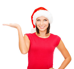 Image showing woman in santa helper hat with something on palm
