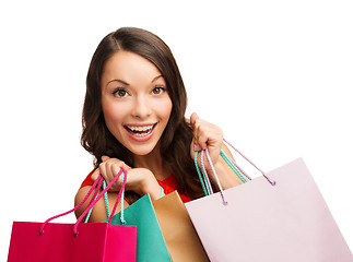 Image showing woman in red dress with shopping bags