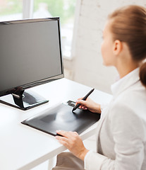 Image showing businesswoman with drawing tablet in office