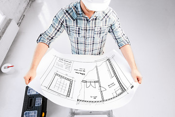 Image showing male architect in helmet with blueprint