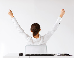 Image showing woman from the back with raised hands