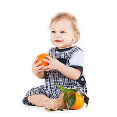 Image showing cute toddler eating orange