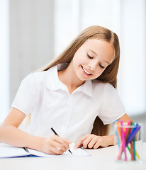 Image showing little student girl drawing at school