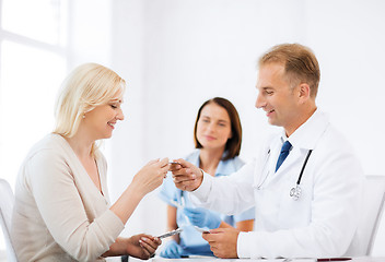 Image showing doctor giving tablets to patient in hospital