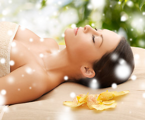 Image showing woman in spa lying on the massage desk