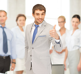 Image showing smiling businessman with thumbs up