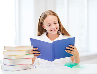 Image showing girl studying and reading book at school