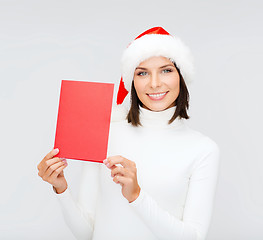 Image showing woman in santa helper hat with blank red card