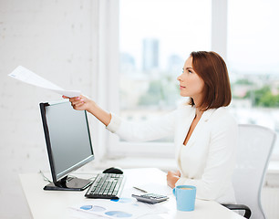 Image showing businesswoman giving papers in office