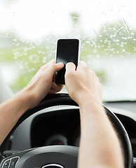 Image showing man using phone while driving the car