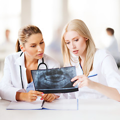 Image showing group of doctors looking at x-ray
