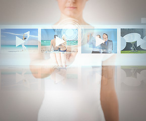 Image showing woman pressing button on virtual screen