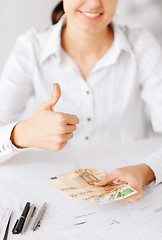 Image showing woman hands with euro cash money and thumbs up