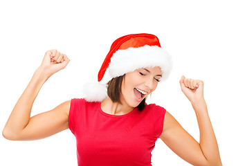 Image showing smiling woman in santa helper hat