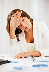 Image showing bored and tired woman with documents