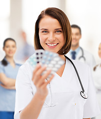 Image showing doctor with blister packs of pills