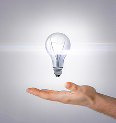 Image showing man hand with light bulb