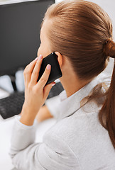 Image showing businesswoman with smartphone in office