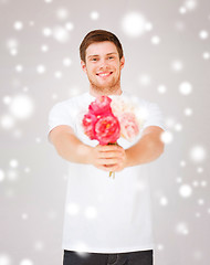 Image showing young man holding bouquet of flowers