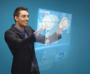 Image showing businessman pressing buttons on virtual screen