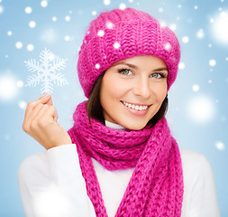 Image showing woman in hat and muffler with big snowflake