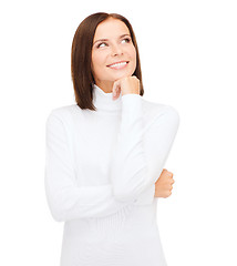 Image showing thinking and smiling woman in white sweater