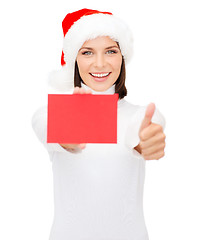 Image showing woman in santa helper hat with blank red card