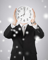 Image showing man with wall clock