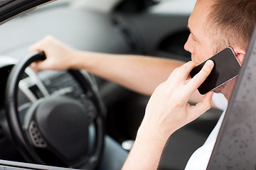 Image showing man using phone while driving the car