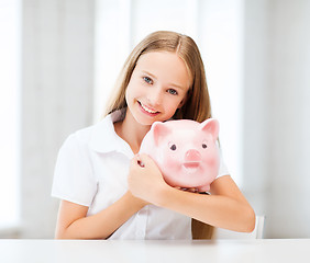 Image showing child with piggy bank