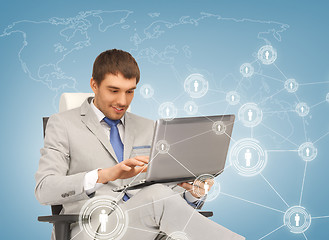 Image showing businessman networking with laptop
