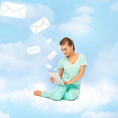 Image showing woman sitting on the cloud with tablet pc