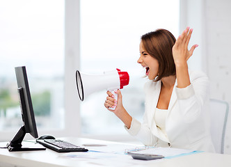 Image showing strict businesswoman shouting in megaphone