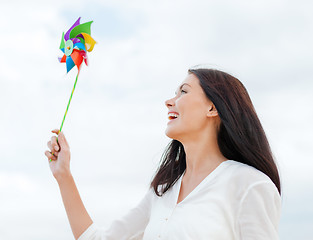 Image showing girl with windmill toy on the beach