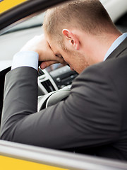 Image showing tired businessman or taxi car driver