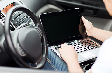 Image showing man using laptop computer in car