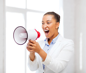 Image showing strict businesswoman shouting in megaphone