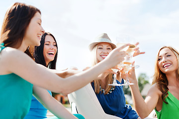 Image showing girls with champagne glasses on boat