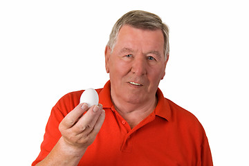 Image showing Old man holding an egg