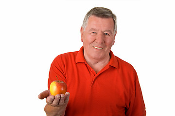 Image showing Old man holding an apple