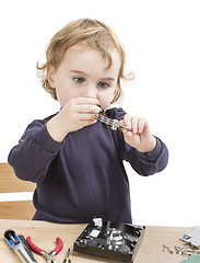 Image showing little girl repairing computer parts