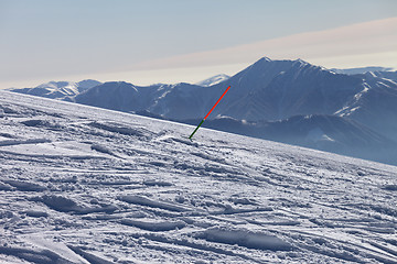 Image showing Ski slope with trace from ski and snowboards at sun day